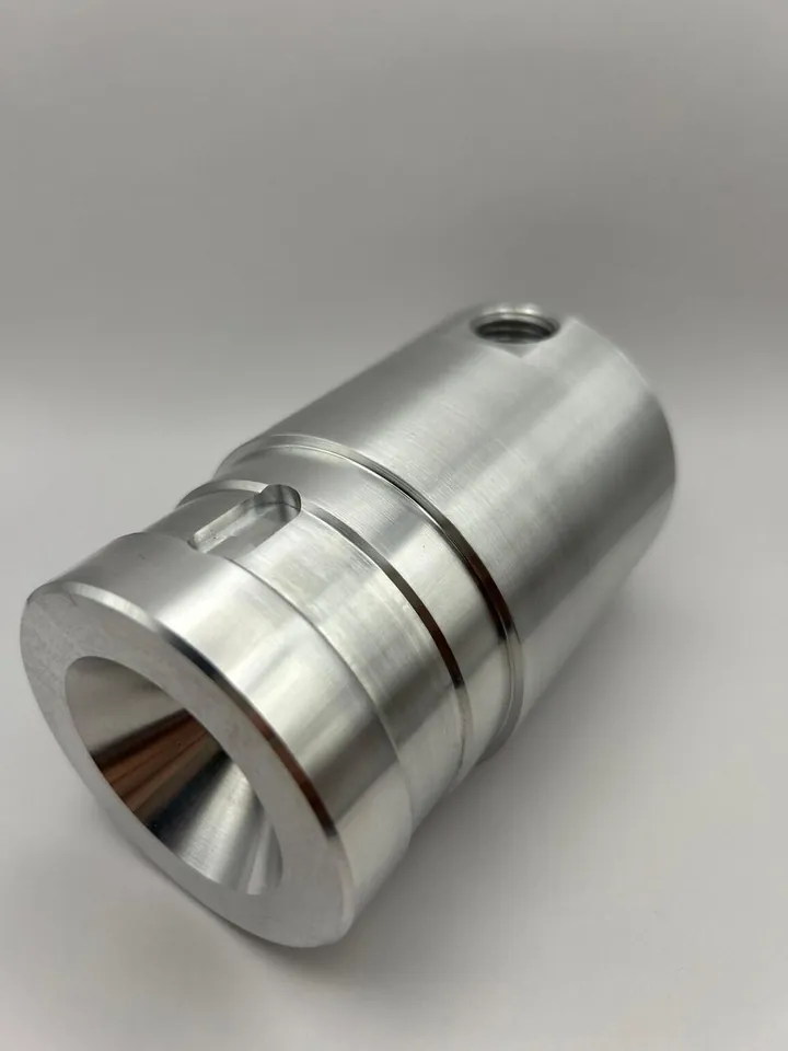 Turned aluminium nozzle body with an internal cone
