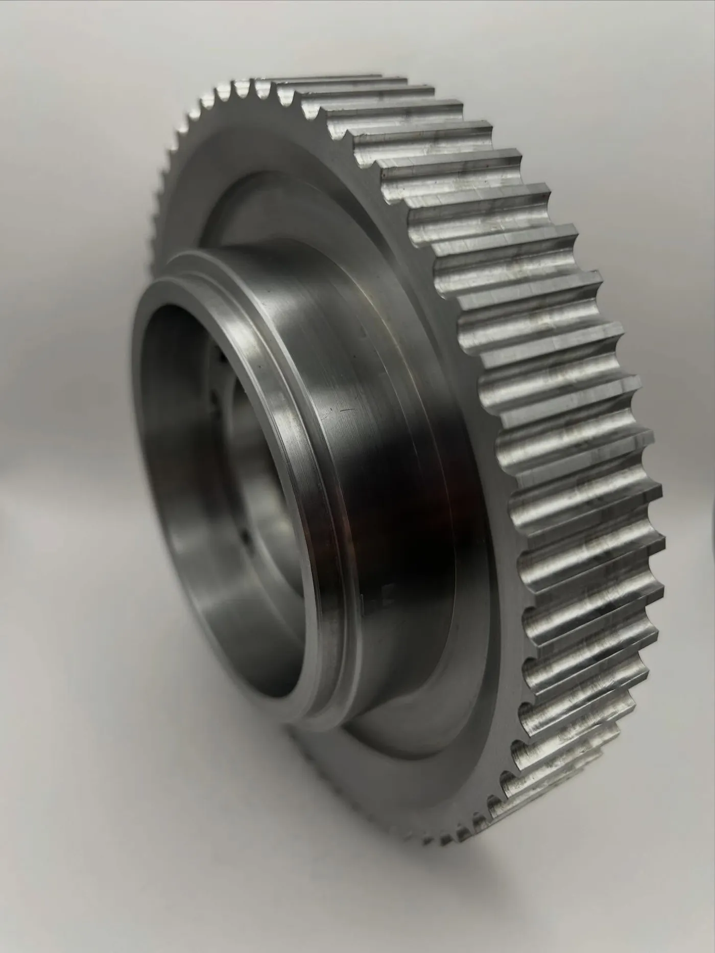 Turned steel timing pulley with cut teeth and a stepped bore